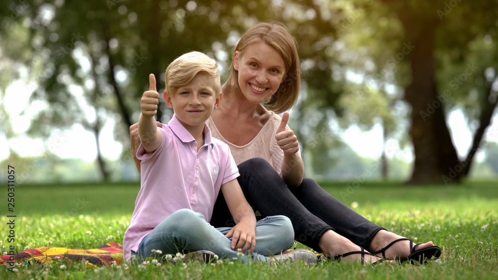 Happy woman and boy showing thumbs up, ad of social support for single mothers